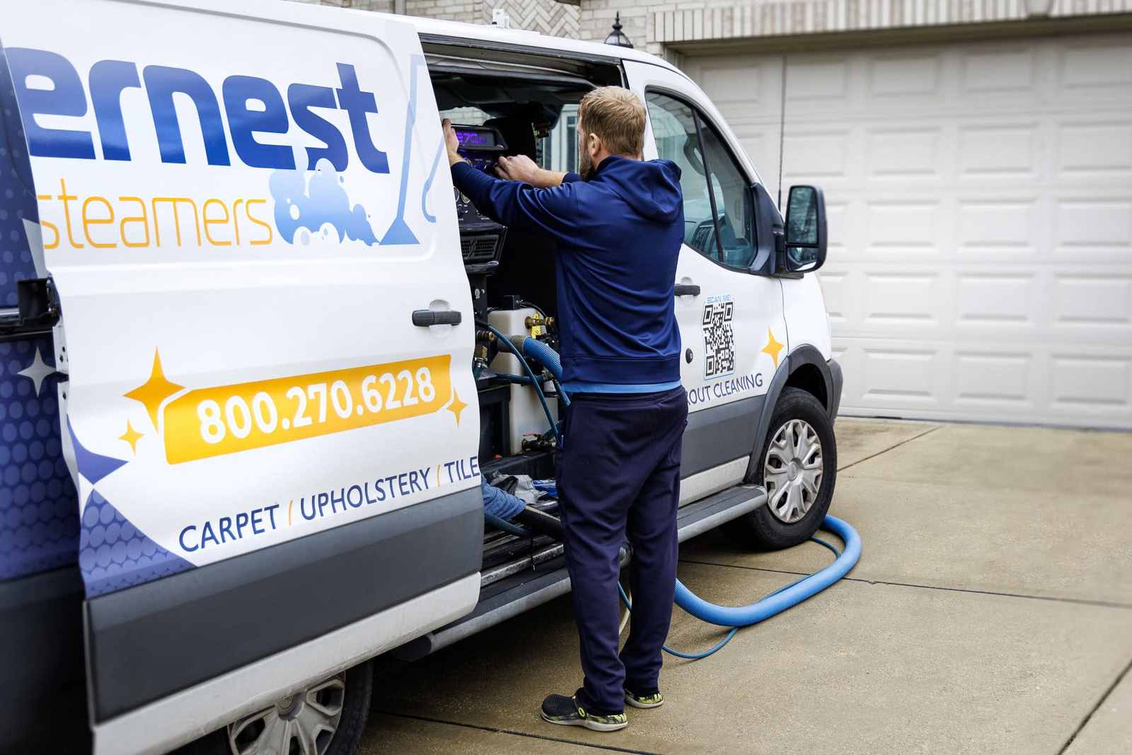 Technician preparing the truck-mounted cleaner inside the Ernest Steamers van
