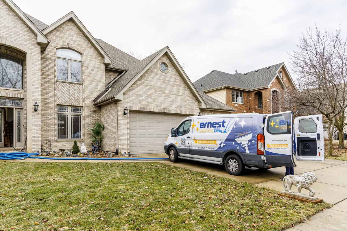 Ernest Steamers van parked in the driveway of a brick house